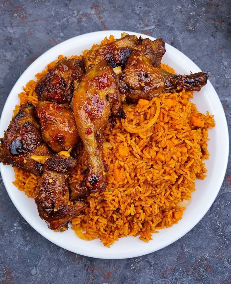 Smoky Nigerian jollof rice served with grilled chicken
